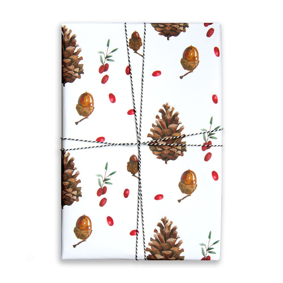 Paper Parade Stationers. Illustrated Christmas gift wrap sheet with watercolour pinecone and berries pattern. Matching gift tags available.